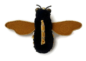 Bee-shaped jewelry with black body, brown wings, and gold accents 