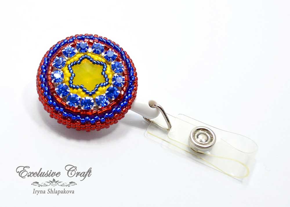 Retractable red yellow blue beaded ID badge Ecuador with